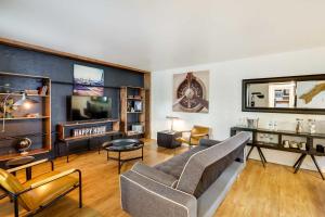a living room with a couch and a tv at Contemporary Dallas Condo with Pool Access! in Dallas