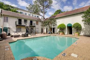 a swimming pool in front of a building at Contemporary Dallas Condo with Pool Access! in Dallas