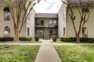 a building with trees in front of it at Contemporary Dallas Condo with Pool Access! in Dallas