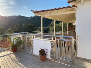 a balcony of a house with a roof at Villa Valmas in Skiathos