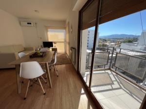 a living room with a desk and a balcony at TRESOR TReS in San Luis