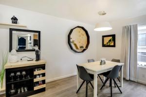 a dining room with a table and chairs and a mirror at Serene Dallas Vacation Rental - Walkable Location! in Dallas