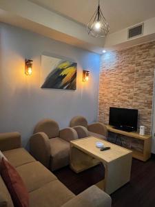 a living room with a couch and a tv at sea view house in Marsa Alam City