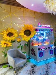 a room with a candy machine and flowers and a chair at Thanh Cong Hotel Ha Long in Ha Long