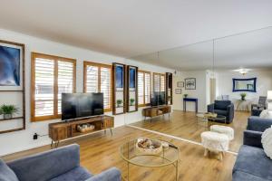 a living room with a couch and a tv at Stylish Condo with Pool in Knox Henderson! in Dallas