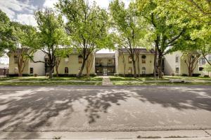 an empty street in front of a building with trees at Stylish Condo with Pool in Knox Henderson! in Dallas