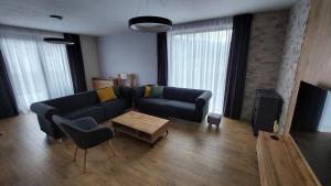 a living room with a couch and a table at Chalet Prestige in Stará Turá