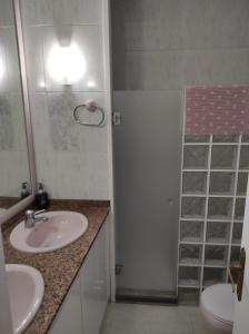 a bathroom with two sinks and a shower and a toilet at Casa Castro in Els Muntells