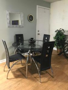 a dining room table with black chairs and a mirror at Your Getaway Home / Finished Basement Private Entry in Palmetto