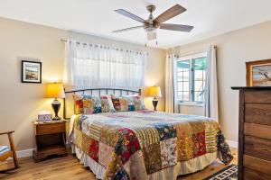 a bedroom with a bed and a ceiling fan at Netport Oasis in Arroyo Grande