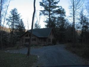 a log cabin in the middle of a forest at Charming, Quiet, Modern, River Front in Hillsdale