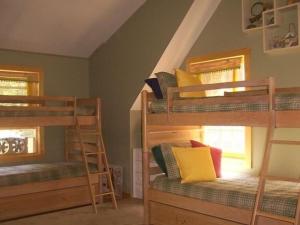 a room with three bunk beds and a window at Charming, Quiet, Modern, River Front in Hillsdale
