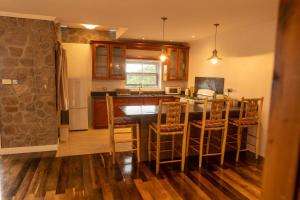 a kitchen with a table and chairs and a counter at Belle Etoile in Soufrière