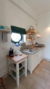 a small kitchen with a sink and a table at Tenuta alla Castellana in Gallipoli