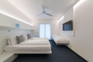 Ένα ή περισσότερα κρεβάτια σε δωμάτιο στο Hotel Santoni Freelosophy ***