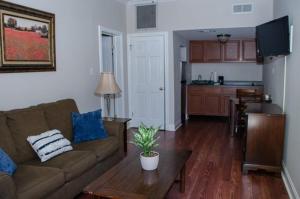 a living room with a couch and a table at Jean Lafitte House in New Orleans