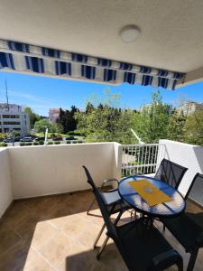 a patio with a table and chairs on a balcony at Adriatic Apartment in Bar