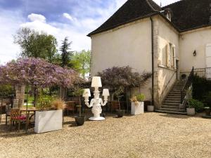 einen Innenhof eines Hauses mit einer Statue im Hof in der Unterkunft Domaine Pont Juillet in Fontaines