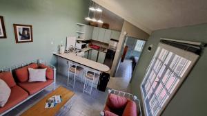 a small living room with a couch and a kitchen at Kootney Resorts in Portsmouth