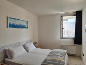 sypialnia z łóżkiem i oknem w obiekcie GRADO APPARTAMENTO HUNGARIA w Grado