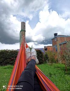 a person with their feet on a hammock at Villa Isabel - Casa Rural in Paipa