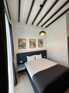 a bedroom with a bed with a black head board at Konak lapta House in Kyrenia