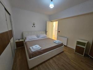 ein Schlafzimmer mit einem Bett mit zwei Handtüchern darauf in der Unterkunft Tirana Central Exclusive in Tirana