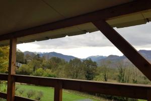 a view of the mountains from the porch of a house at Chalet avec terrasse face aux Pyrénées in Bartrés