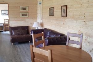 - un salon avec un canapé, une table et des chaises dans l'établissement Chalet avec terrasse face aux Pyrénées, à Bartrés