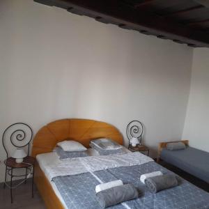 - une chambre avec un lit en bois et des serviettes dans l'établissement Recece vendégház, à Gyepükaján