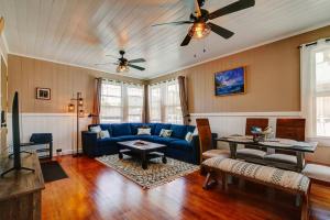 a living room with a blue couch and a table at NEW Paddler's Inn- 3BR Hilo Downtown in Hilo
