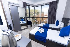 a hotel room with two beds and a view at Bloom Hotel Yerevan in Yerevan