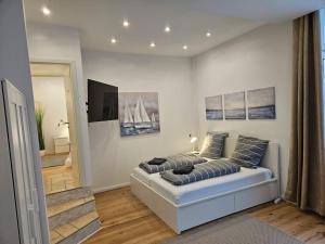 a bedroom with a bed with pillows on it at Central City White Line in Kiel
