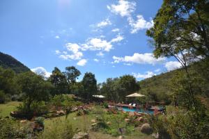a resort with a swimming pool and a mountain at Rocky Drift Private Nature Reserve in Waterval Boven
