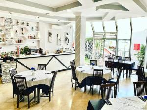 a restaurant with tables and chairs and a counter at Antomax Apartment in Costa del Silencio - WI FI in Costa Del Silencio