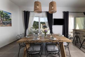 a dining room with a wooden table and chairs at Tilagus holiday villa - Perla in Žman