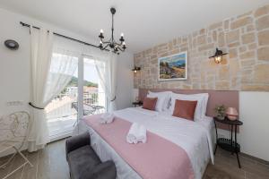 a bedroom with a large bed with towels on it at Tilagus holiday villa - Perla in Žman