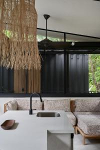 a living room with a sink and a couch at Casa Alba - Portasol Vacation in Savegre