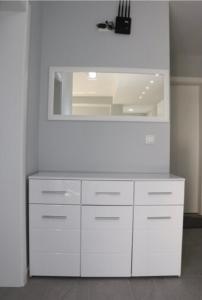 a white dresser with a mirror in a room at FAMILY-FRIENDLY APARTMENTS in Donji Štoj
