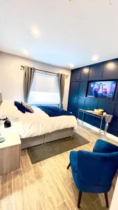 a bedroom with a large bed and a tv at The King's Parlour Whitehead in Whitehead