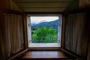 an open window with a view of a mountain at Casa Soleggiata in Mazzola
