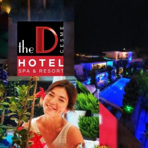 a woman standing in front of a hotel sign at The D Hotel Spa & Resort in Çeşme