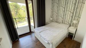 Posteľ alebo postele v izbe v ubytovaní Apartament nad jeziorem , ZEFIR