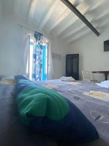 a large bed with a green pillow on top of it at I 5 PASSI in Filicudi