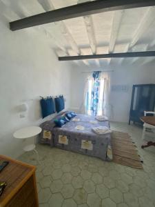 a bedroom with a bed and a table in a room at I 5 PASSI in Filicudi