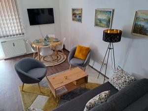 a living room with a couch and a table at Rózsa Apartman Keszthely in Keszthely
