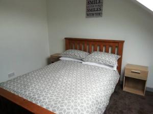 a bed with two pillows on it in a bedroom at Haverfordwest terraced home in Pembrokeshire