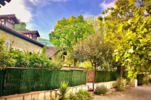 a fence in front of a house with trees at Casa rural Paraje de Yuste in Cuacos de Yuste