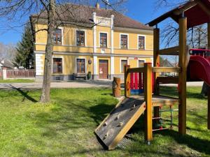 a playground with a slide in front of a building at Chalupa Sviny 