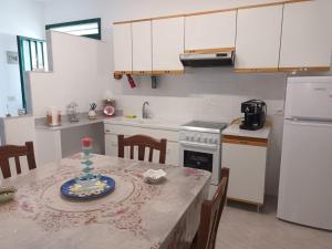 a kitchen with a table with a plate on it at Blue Sea Apartment in Punta Braccetto